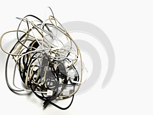 Headphones and connecting cables get tangled up. On a white background, the concept of chaos. to give a feeling of despondency,