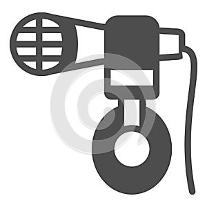 Headphones hang on microphone solid icon, sound design concept, mic and headset vector sign on white background, glyph