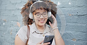 Headphones, mobile or happy woman in city dancing, texting or streaming a song, music or radio. Relax, phone or person