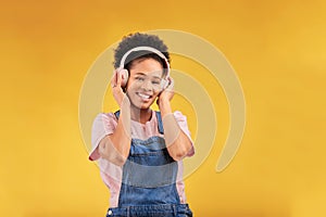 Headphones, music and black woman in portrait, smile and isolated in studio on a yellow background mockup space. Face