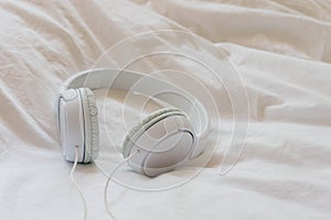 Headphones over a bed. Relaxing moment concept. After-work disconnection