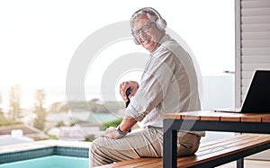 Headphones, patio and portrait of senior man by pool in backyard for relaxing, chill and podcast. Retirement home, happy