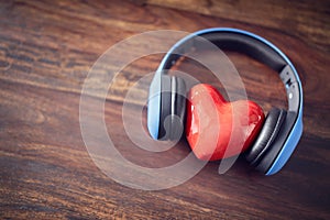 Headphones and red heart background concept for love listening to music