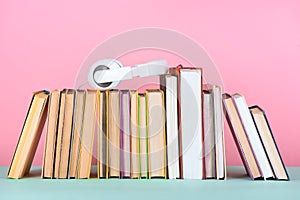 headphones on row of books on table