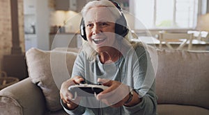 Headphones, senior woman and joystick for video game, online streaming and relax for retirement at home. Technology