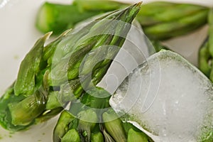 Heads of asparagus close up with ice