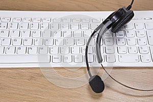 Headset and computer keyboard on desk