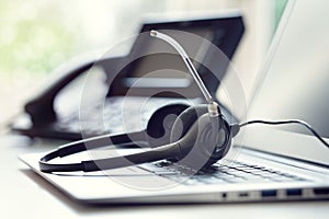 Headset headphones telephone and laptop in call center