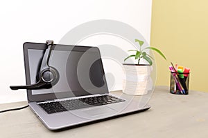 headset on laptop computer, concept for communication, it support, call center and customer service help desk