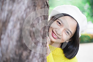 Headshort portrait smile young girl with big tree