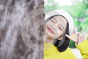 Headshort portrait smile young girl with big tree