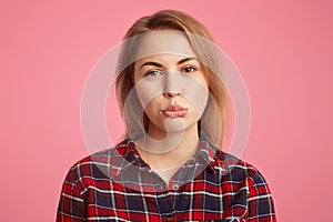 Headshot of abused female with short hair, curves lips with dissatisfaction, being offended with her boyfriend who didn`t come on