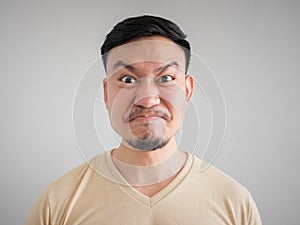 Headshot of angry and mad face of Asian man.