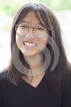 Headshot of asian teenager toothy smiling face with happiness emotion