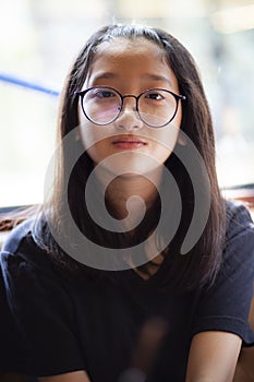 Headshot of asian teenager wearing eyes glasses