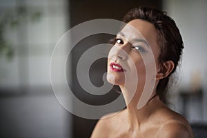 Headshot of an attractive mid aged woman smiling to the camera