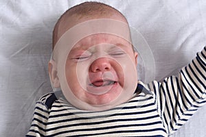 Portrait of a baby lying on the bed photo