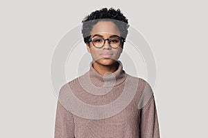 Headshot of black woman in glasses posing isolated in studio photo