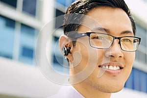 Headshot Business Man With Bluetooth Handsfree Device