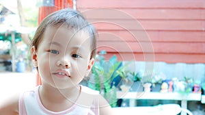 Headshot of charming 3 years old cute baby Asian girl, little toddler child with adorable brown less hair