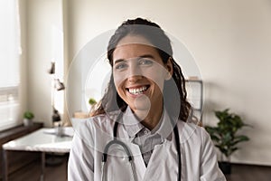 Headshot portrait of smiling female doctor in hospital photo