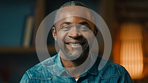 Headshot close-up smiling confident happy african american man looking camera at home satisfied mature guy businessman