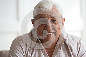 Headshot closeup portrait of happy mature grey-haired man.