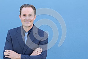 Headshot of confident businessman crossing his arms