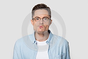 Headshot of confused angry man in eyeglasses looking at camera
