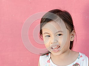 Headshot of dramatic portrait of 4 years old cute baby Asian girl, little toddler child with adorable short hair looking at camera