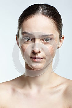 Headshot of emotional female face portrait with angry facial expression