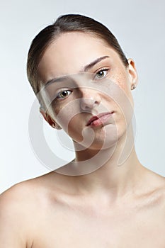 Headshot of emotional female face portrait with calm and tender facial expression