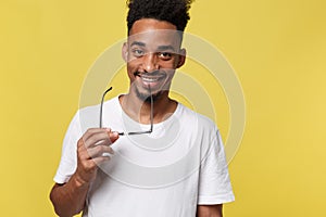 Headshot of good-looking positive young dark-skinned male with stubble and trendy haircut wearing white shirt while