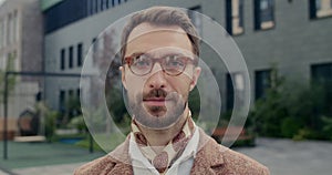 Headshot of handsome man with beard looking to camera. Crop view of stylish male person with serious face expression