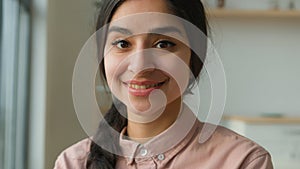 Headshot happy Arabian Indian ethnic millennial woman student girl businesswoman near window female housewife homeowner