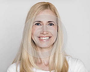 Headshot of happy middle-aged woman with perfect soft skin