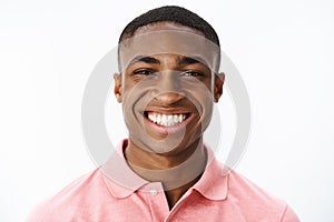 Headshot of happy successful and delighted young african american male student smiling broadly with joy and delight