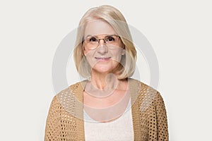 Headshot of mature woman wearing glasses looking at camera
