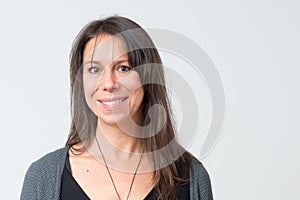 Headshot of a mediterranean woman aged 30-40 with a friendly big smile