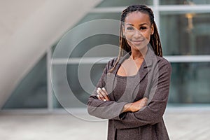 Headshot portrait of an african american female business executive in a suit outside the office workplace