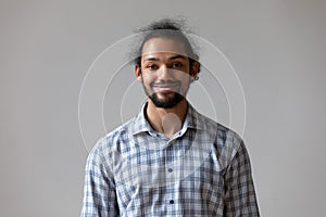 Headshot portrait African single man posing against studio wall background