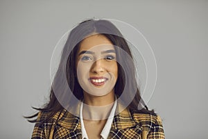Headshot portrait of attractive millennial hispanic woman isolated on copy space photo