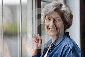 Headshot portrait of attractive senior woman enjoy life in retirement