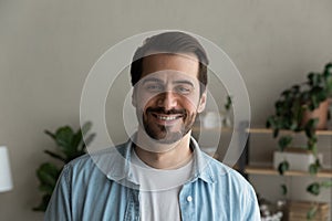 Headshot portrait of bearded caucasian smiling man