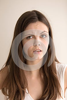 Headshot portrait of disappointed young woman