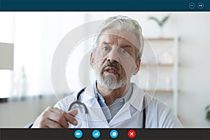 Headshot portrait of elderly male doctor consult patient online