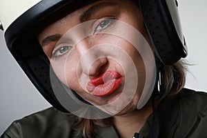 Headshot portrait of fashion girl with red lips in biker leather jacket looking at camera over white background.