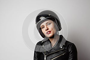 Headshot Portrait of girl with red lips in black leather jacket smiling looking at camera. White background