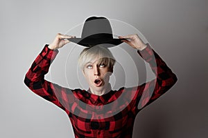 Headshot Portrait of happy blonde girl with black hat smiling looking at camera. White background. Fashion, glamour and