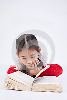 Headshot Portrait of happy cute girl reading a book .